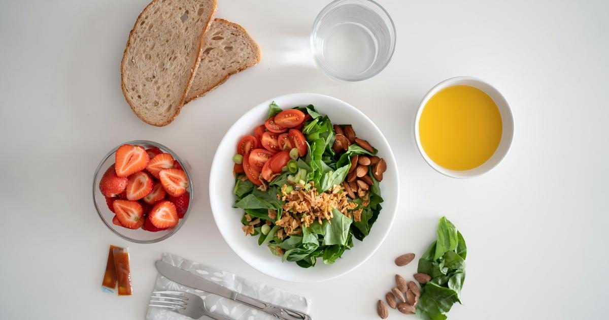 A healthy meal featuring fresh vegetables and whole grains, contrasting with packaged processed snacks.