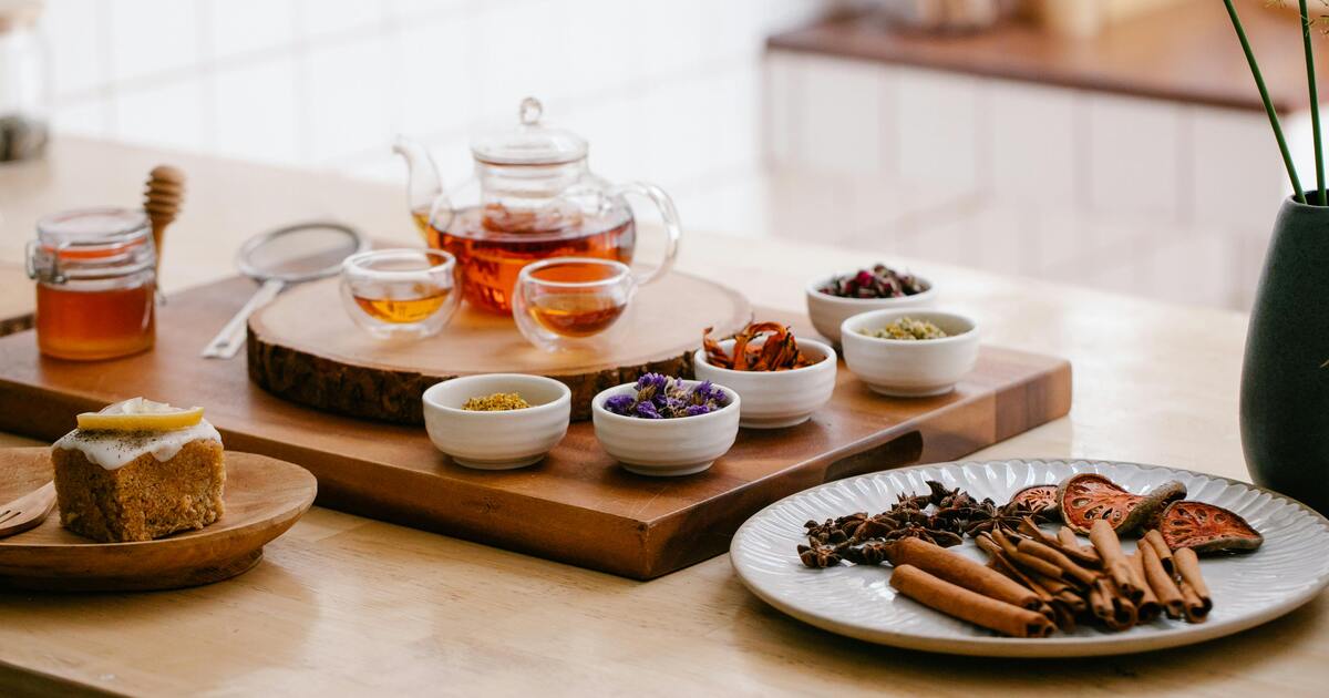 A warm cup of caffeine-free herbal tea on a bedside table