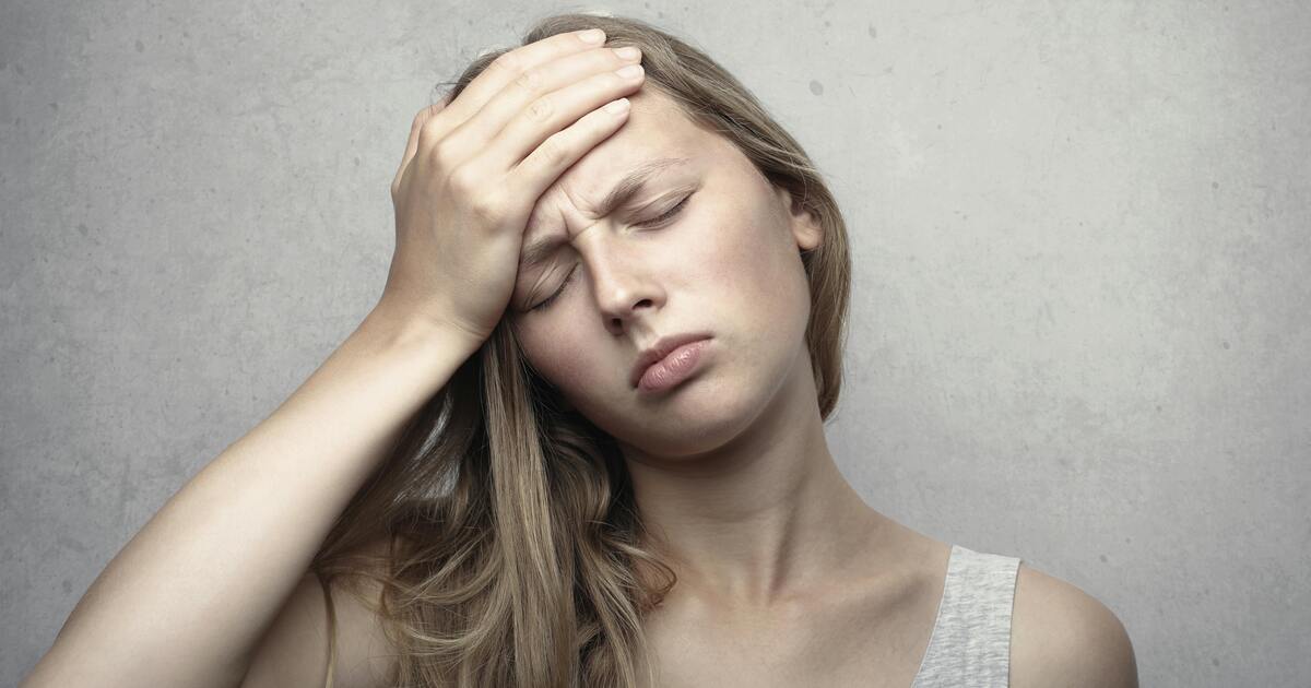 A woman looking tired and stressed, representing common symptoms of hormonal imbalance